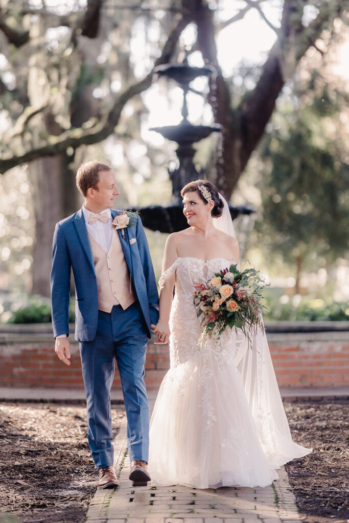 Savannah fall wedding with bride wearing a lace mermaid dress and fall bouquet.