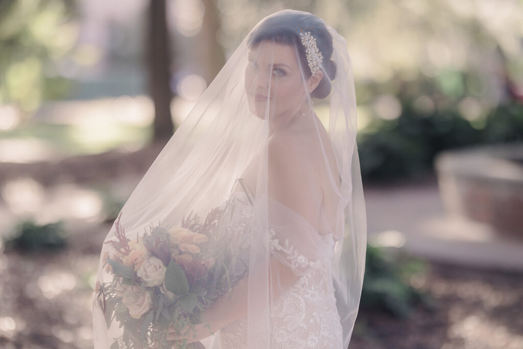 Bridal portrait with veil over her face.