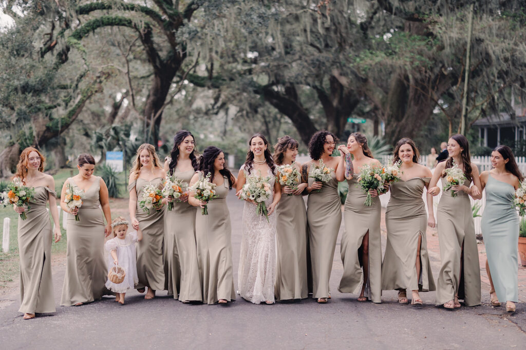 Tan bridesmaids' dresses with fall colored bouquets.