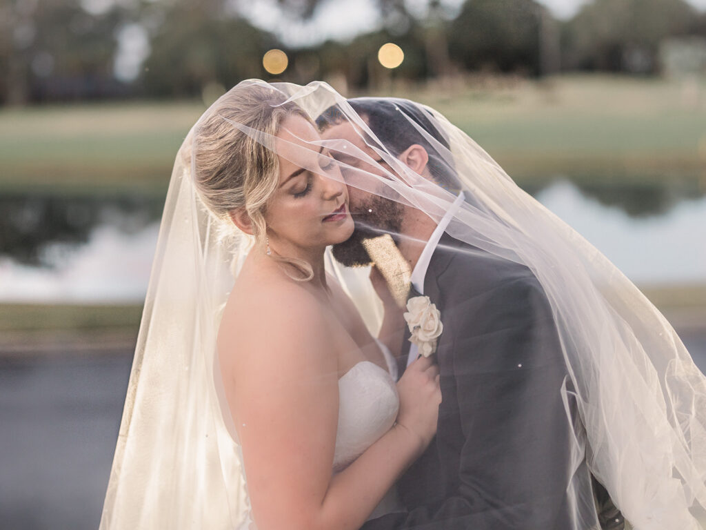 Wedding First Look - Bride and groom pose for romantic photo at sunset. 
