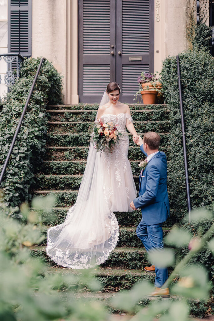 Savannah fall wedding with bride wearing a lace mermaid dress and fall bouquet.
