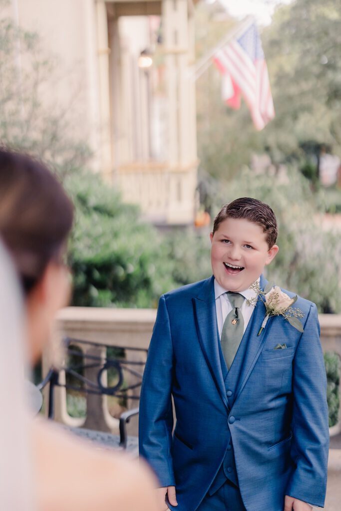 Bride's son sees his mom for the first time in her wedding gown.