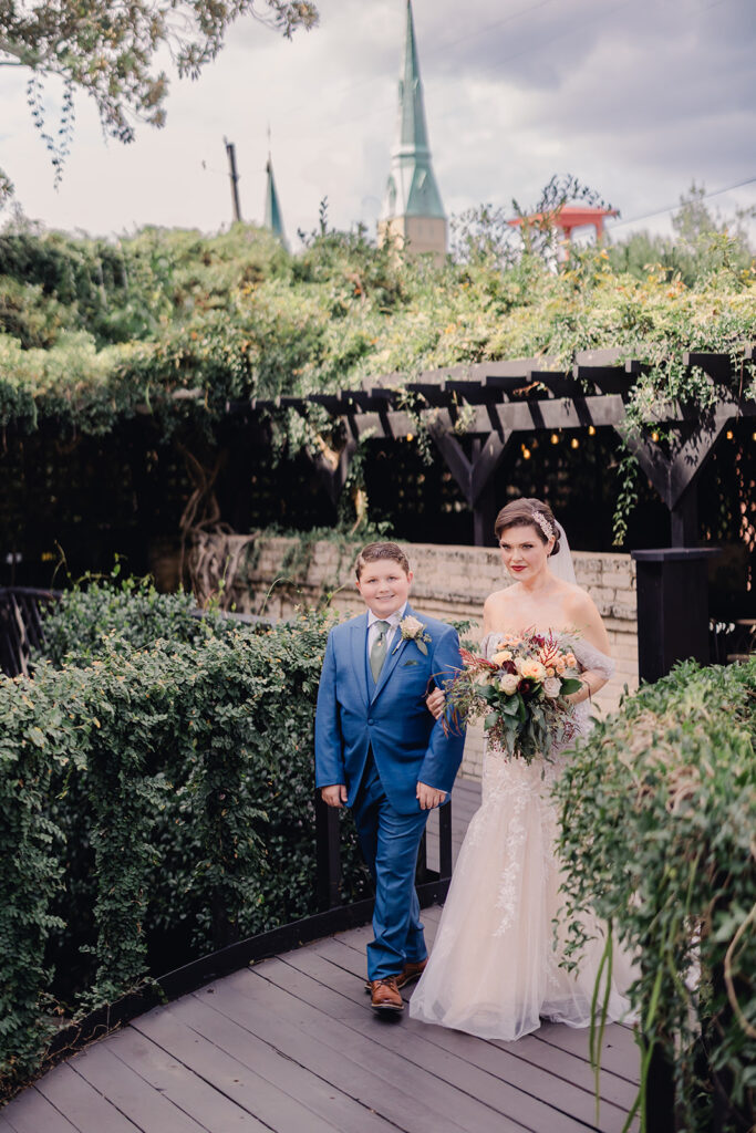 Bride walks down the aisle with her son.