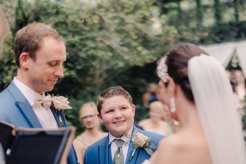 Bride's son looks at mom during wedding ceremony.