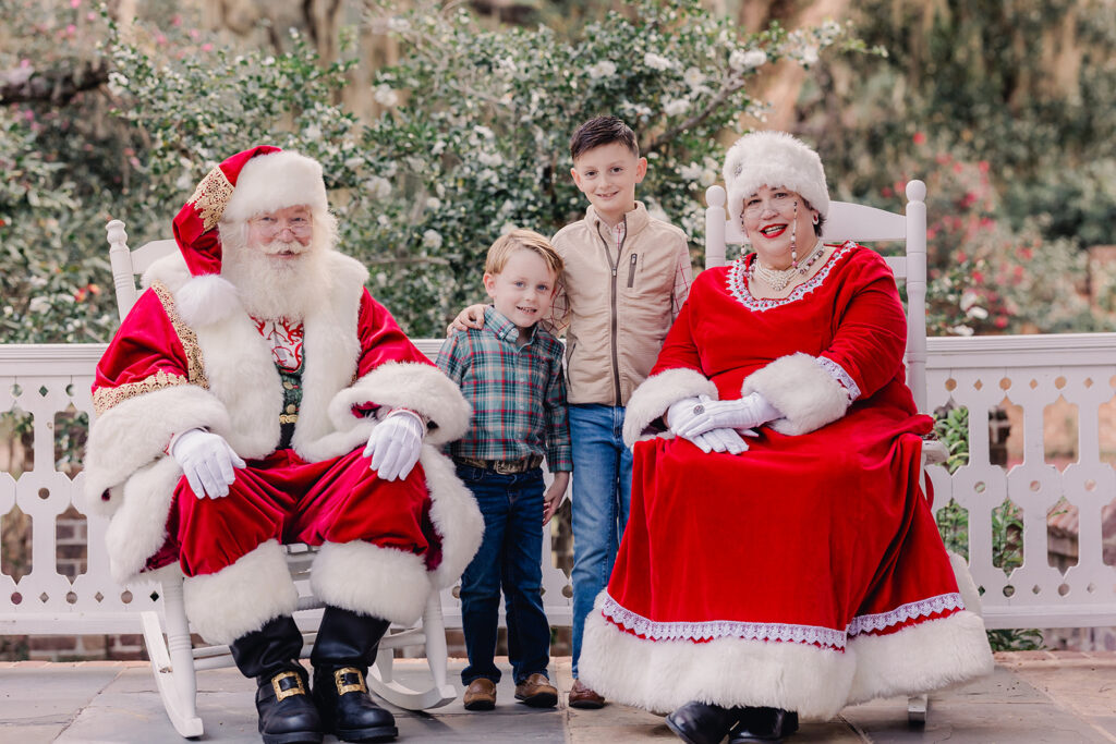 Santa and Mrs. Clause sit with kids on the 'Nice List'.
