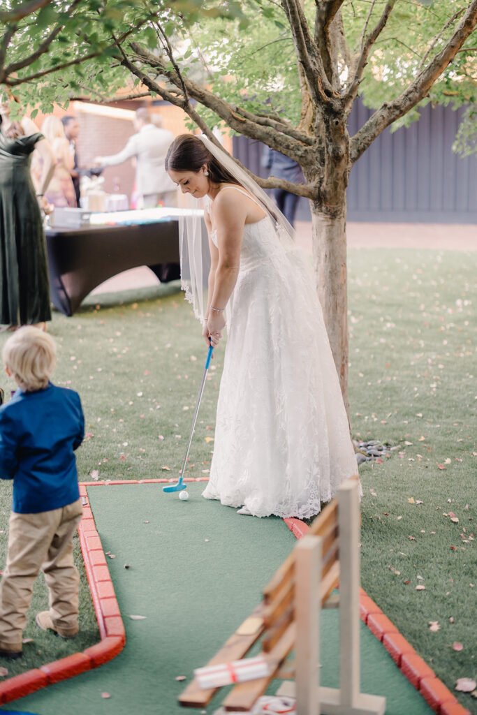 Wedding First Look - Bride and groom play mini-golf at cocktail hour.