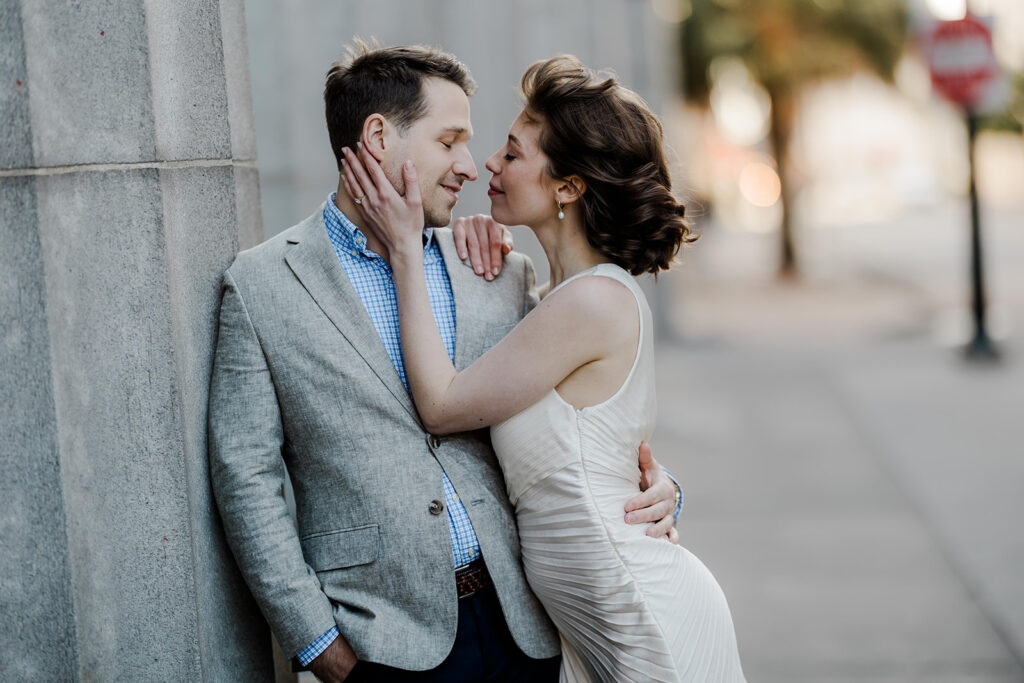 Bride and groom in neutral engagement photo outfits during urban session.